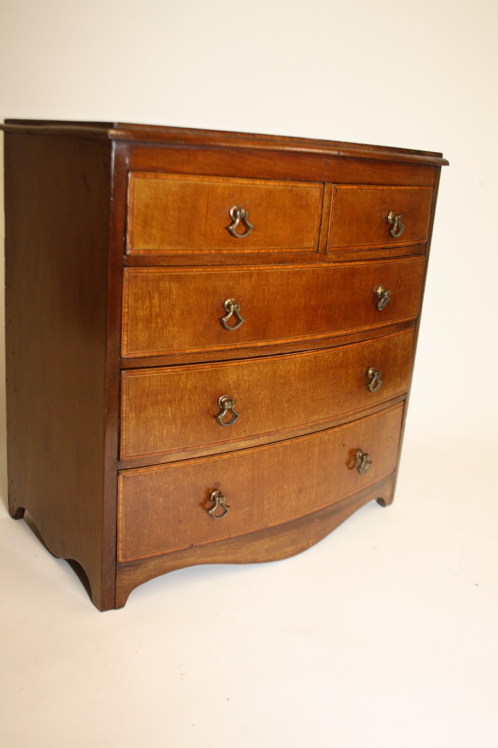 Late 19th century bow front miniature chest of drawers View II