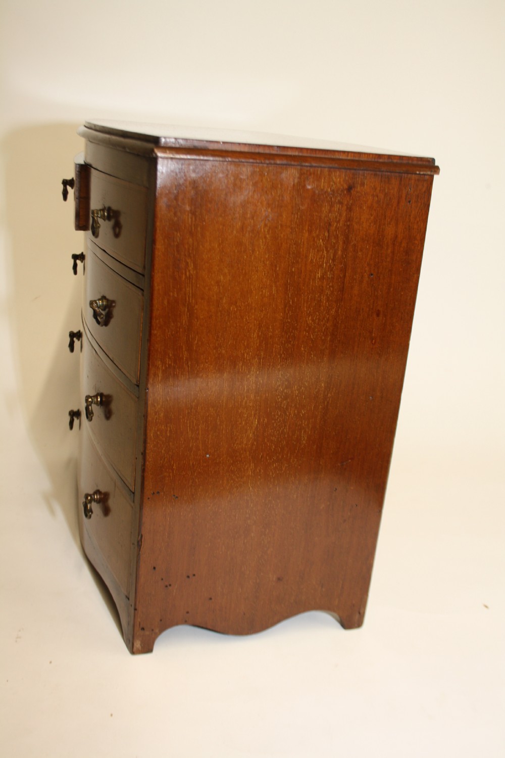 Late 19th century bow front miniature chest of drawers View III