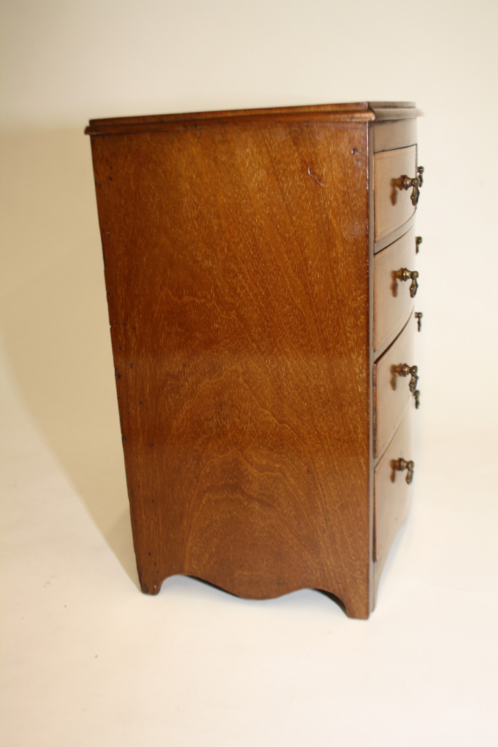 Late 19th century bow front miniature chest of drawers View VI