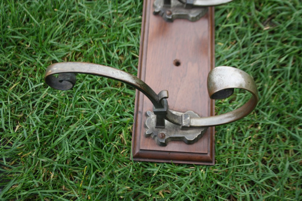 Five Edwardian coat-hooks mounted on walnut View III