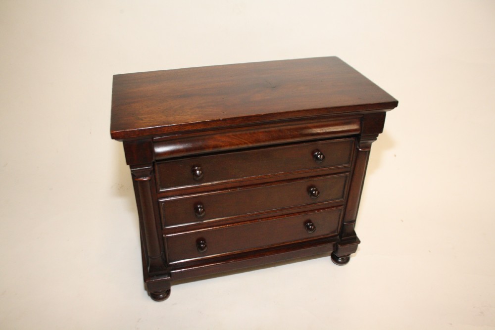 Late 19th century miniature chest of drawers with split bolsters