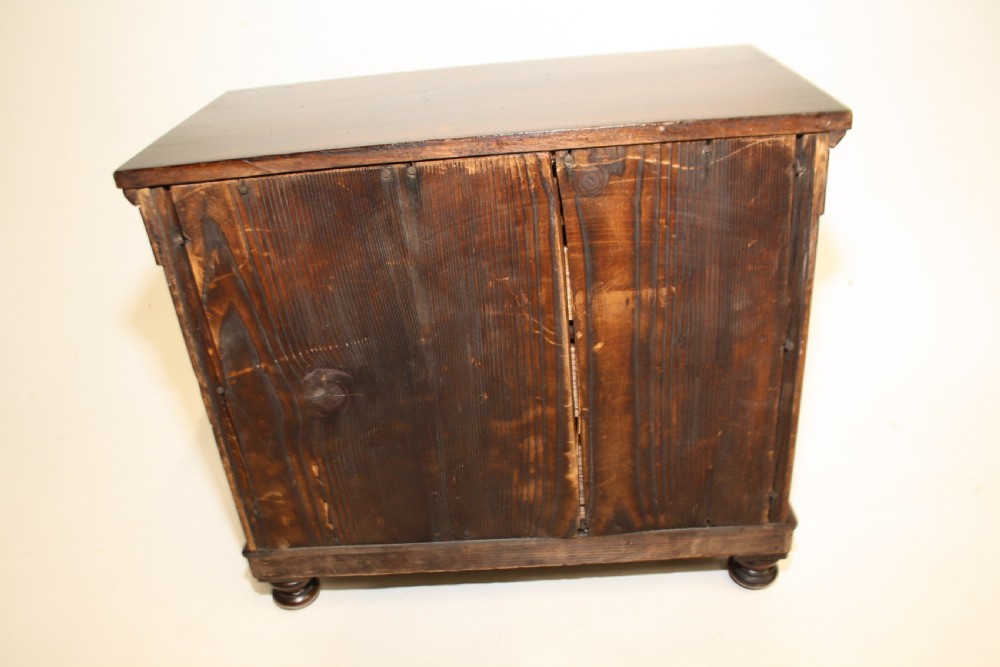 Late 19th century miniature chest of drawers with split bolsters View IX