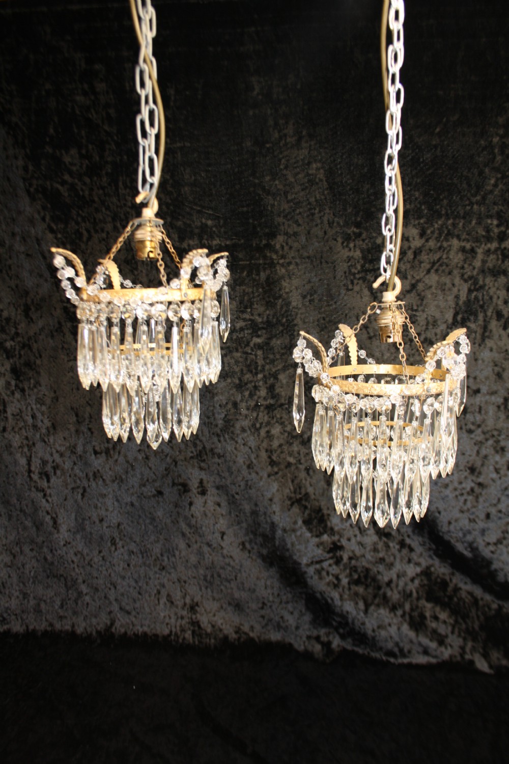 Pair of spike chandeliers with leaves and swags to the top