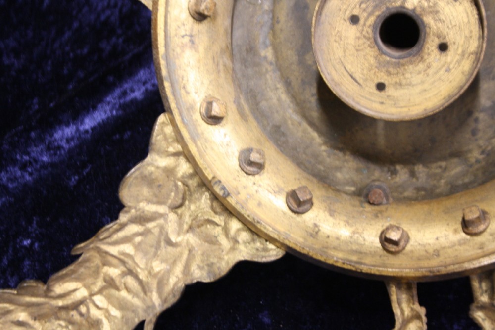 An ornate cast gilt brass ceiling rose featuring three foliate arms, grape and leaf motifs, and a central mounting hook. View III