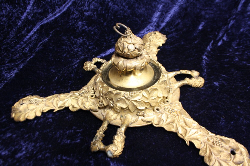 An ornate cast gilt brass ceiling rose featuring three foliate arms, grape and leaf motifs, and a central mounting hook. View IV