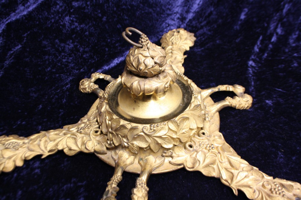 An ornate cast gilt brass ceiling rose featuring three foliate arms, grape and leaf motifs, and a central mounting hook. View VII