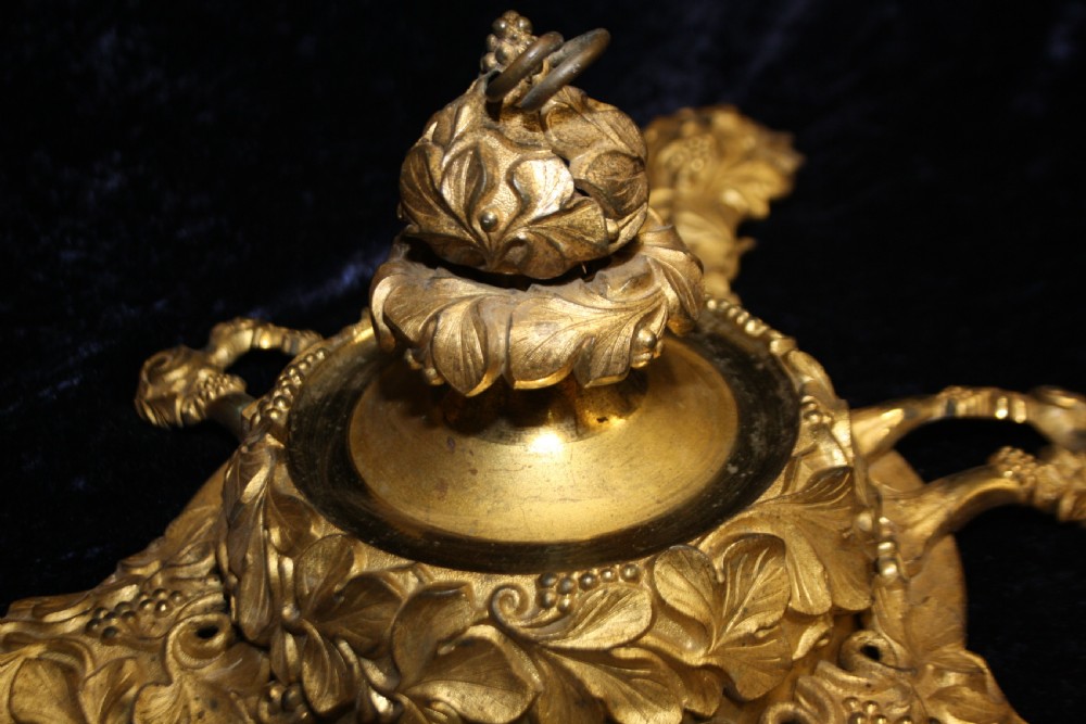 An ornate cast gilt brass ceiling rose featuring three foliate arms, grape and leaf motifs, and a central mounting hook. View X