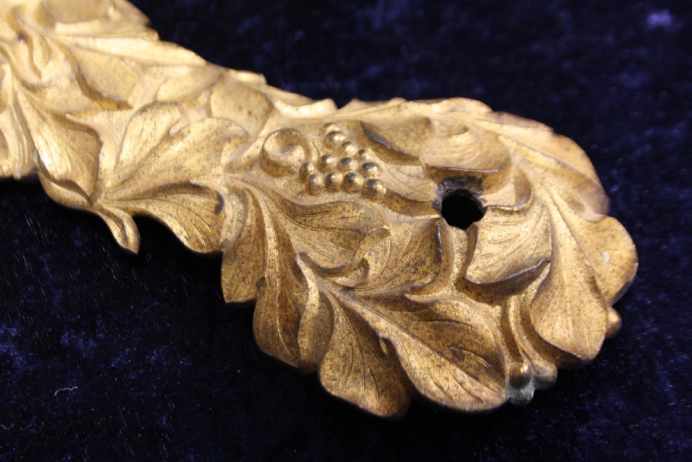 An ornate cast gilt brass ceiling rose featuring three foliate arms, grape and leaf motifs, and a central mounting hook. View XI
