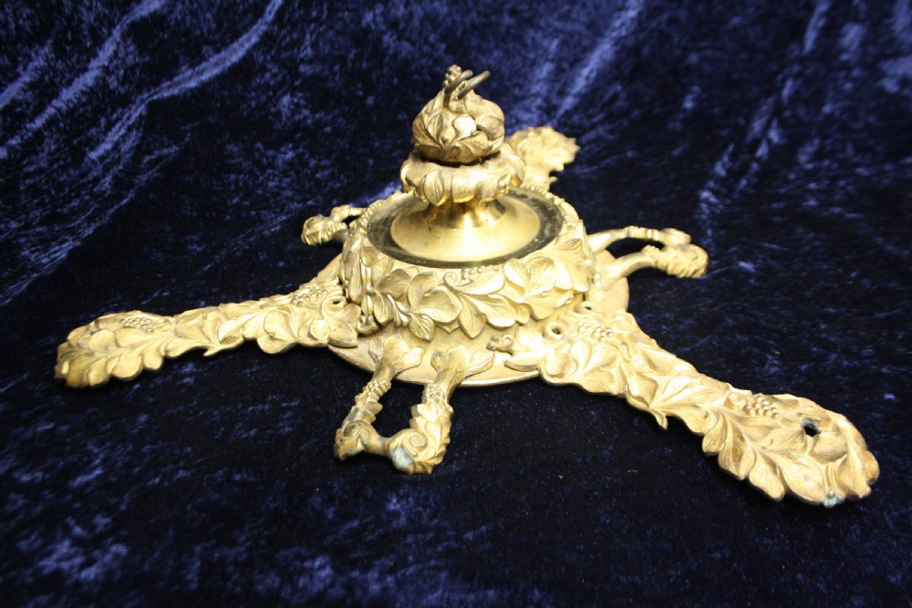 An ornate cast gilt brass ceiling rose featuring three foliate arms, grape and leaf motifs, and a central mounting hook. View XII