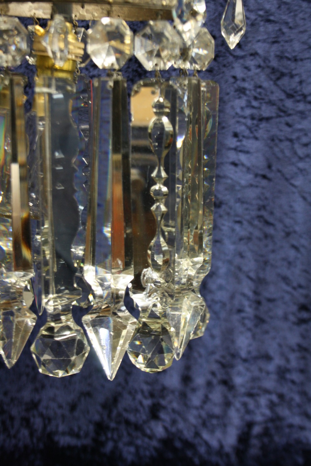 An early 20th century ceiling pendant featuring vertical glass prism lustres suspended from a brass gallery ring and hanging chain. View VII