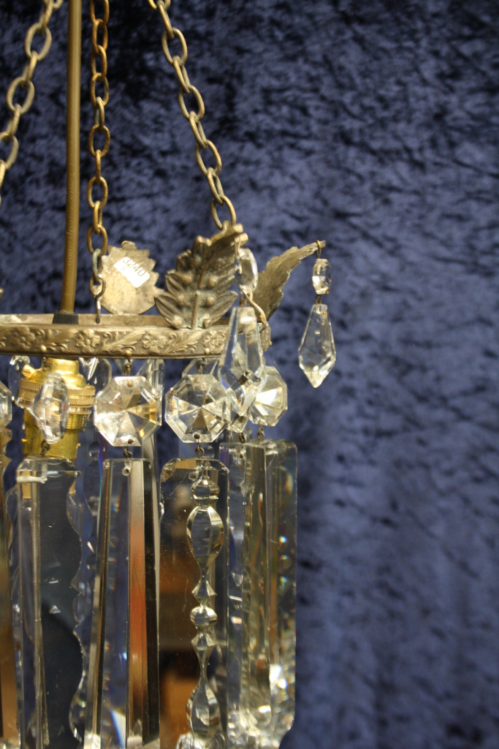 An early 20th century ceiling pendant featuring vertical glass prism lustres suspended from a brass gallery ring and hanging chain. View VIII
