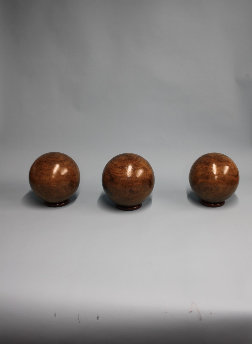 Three lignum vitae balls 8.5