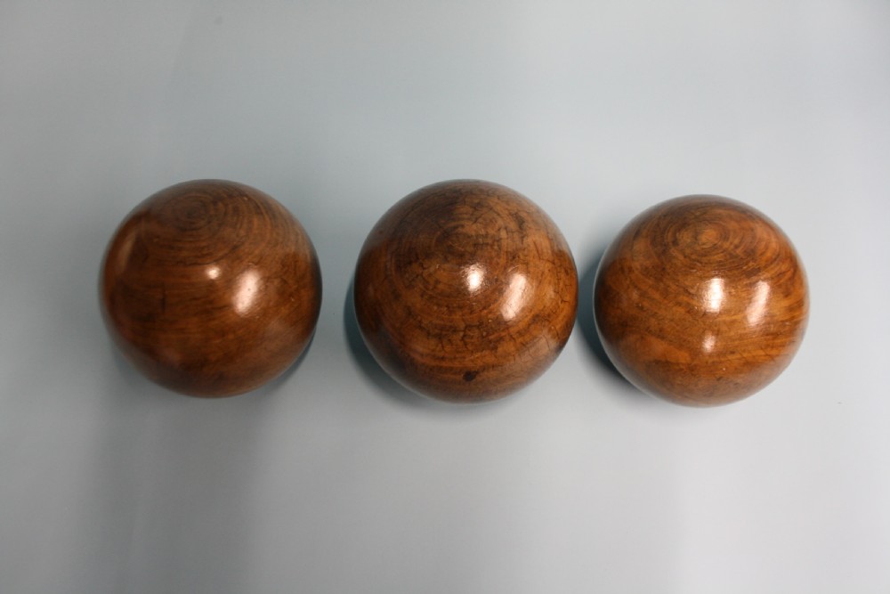 Three lignum vitae balls 8.5