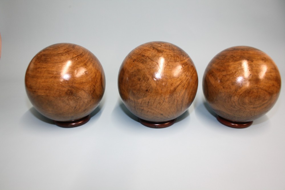Three lignum vitae balls 8.5