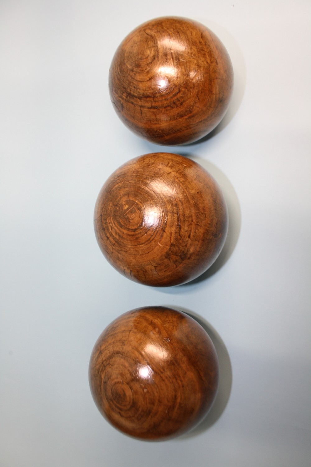 Three lignum vitae balls 8.5