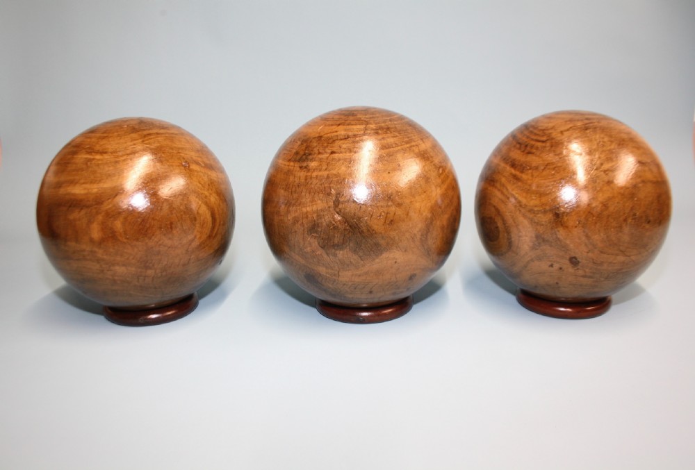 Three lignum vitae balls 8.5