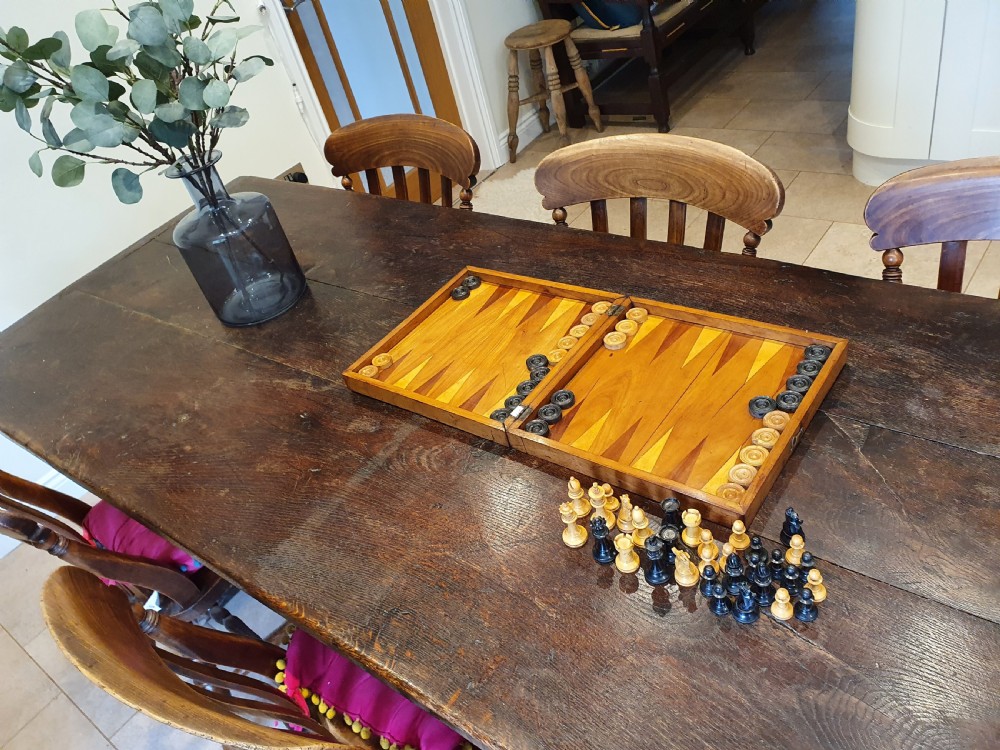 A Victorian wooden folding chess board box displaying full black and natural boxwood Staunton pattern chess pieces. View II