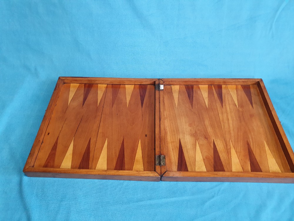 A Victorian wooden folding chess board box displaying full black and natural boxwood Staunton pattern chess pieces. View VIII