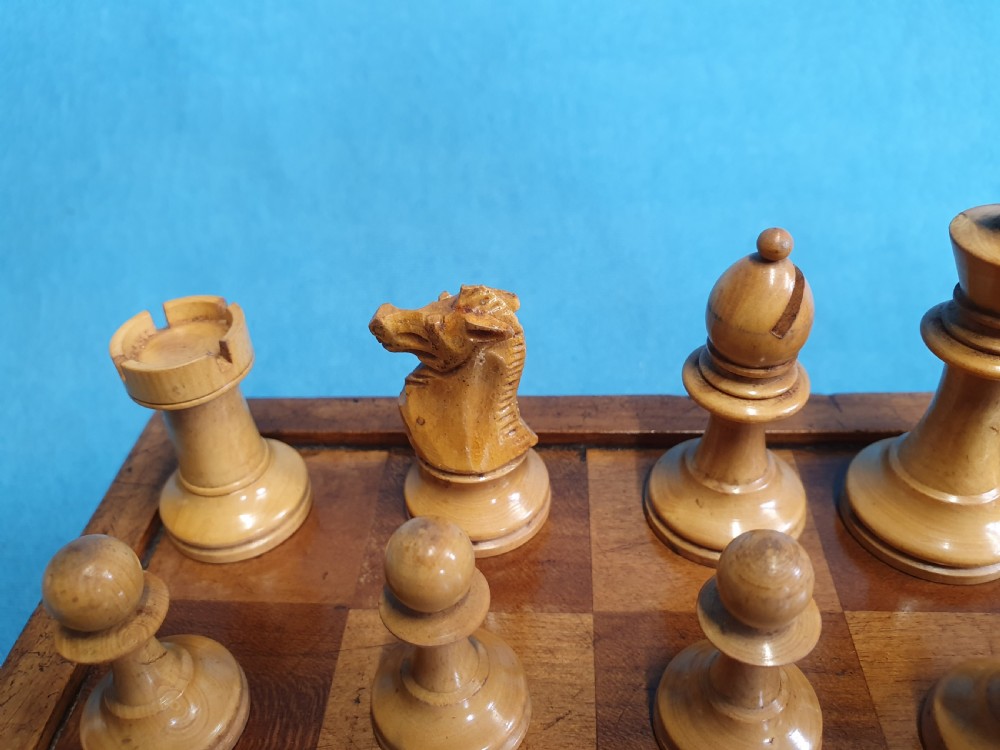 A Victorian wooden folding chess board box displaying full black and natural boxwood Staunton pattern chess pieces. View XI