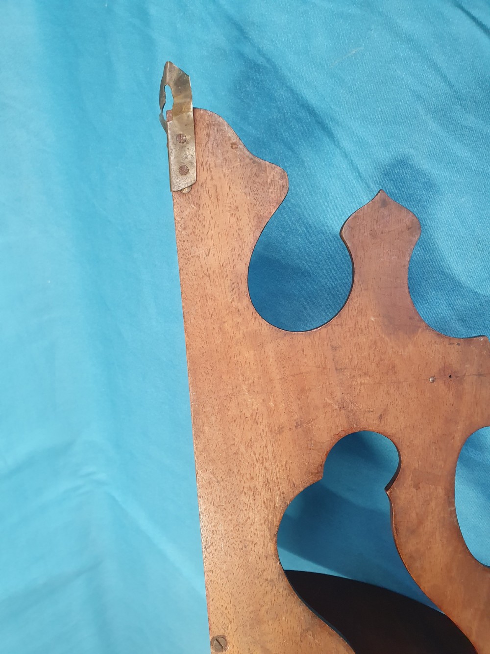 A pair of mid 19th-century mahogany corner wall brackets featuring two triangular display shelves supported by shaped scrollwork fretwork side panels. View II