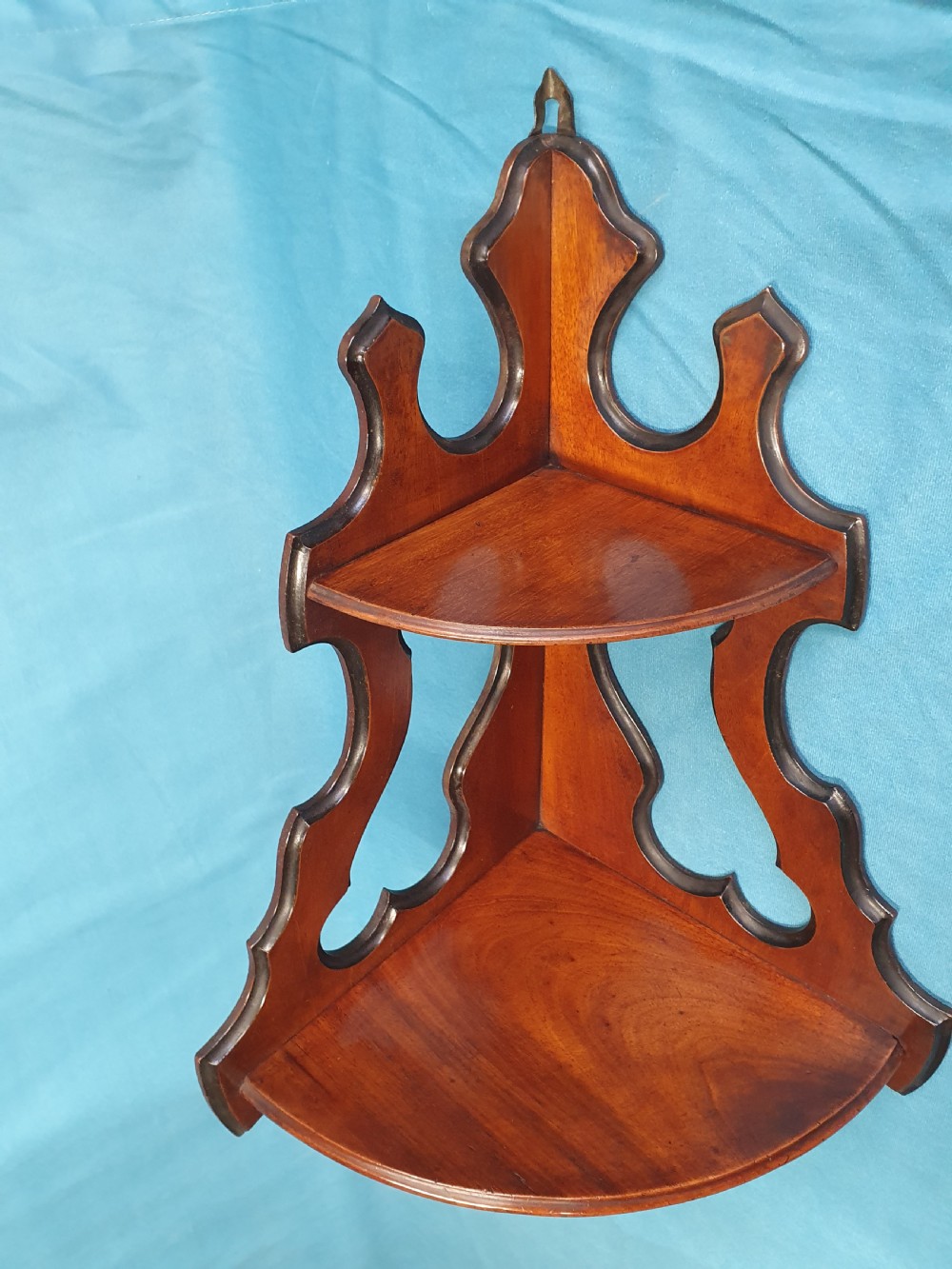 A pair of mid 19th-century mahogany corner wall brackets featuring two triangular display shelves supported by shaped scrollwork fretwork side panels. View VI