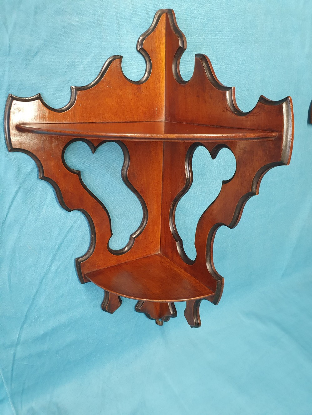 A pair of mid 19th-century mahogany corner wall brackets featuring two triangular display shelves supported by shaped scrollwork fretwork side panels. View VII
