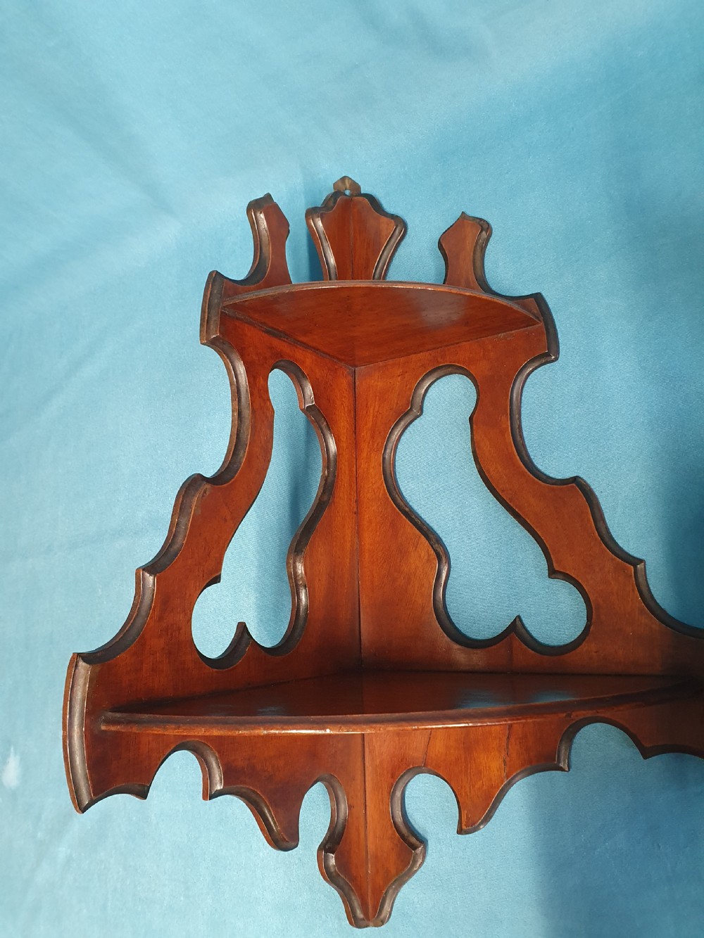 A pair of mid 19th-century mahogany corner wall brackets featuring two triangular display shelves supported by shaped scrollwork fretwork side panels. View VIII