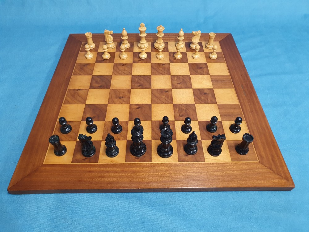 Early 20th century chess board made by Jacks of London with chess set