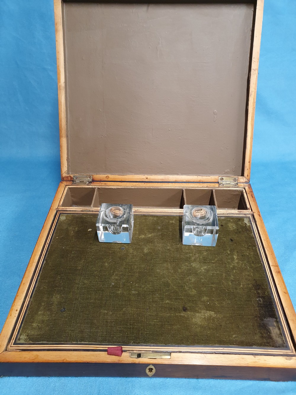 A 19th-century rectangular wooden writing slope featuring geometric tumbling block parquetry inlay and a brass keyhole escutcheon. View VIII