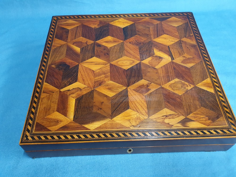 A 19th-century rectangular wooden writing slope featuring geometric tumbling block parquetry inlay and a brass keyhole escutcheon. View IX