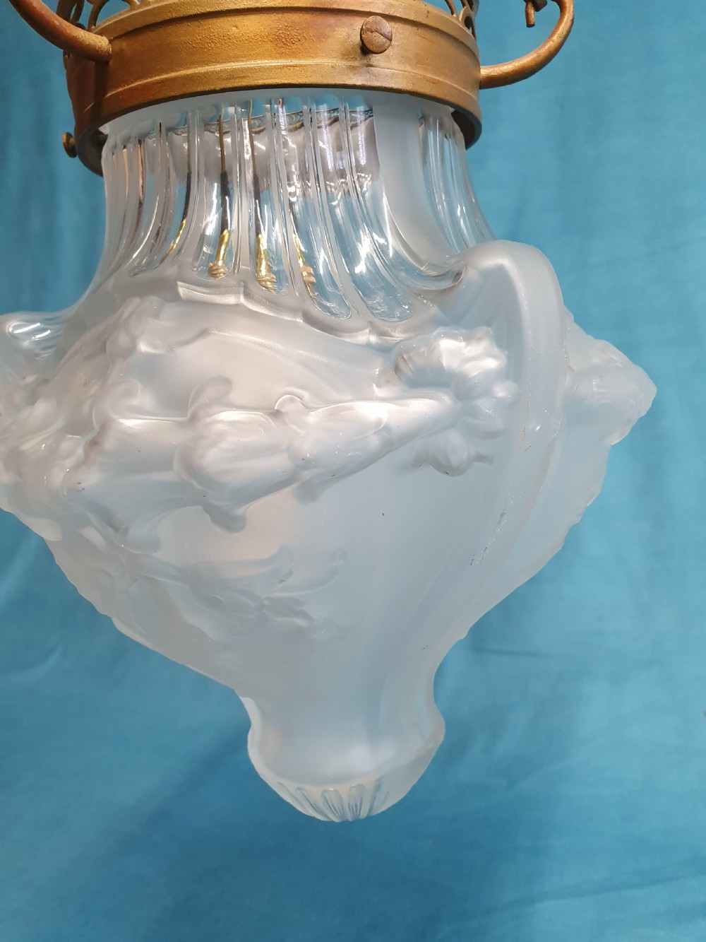 An early 20th-century glass pendant light with a frosted and moulded glass shade suspended by brass chains from a decorative brass gallery. View III