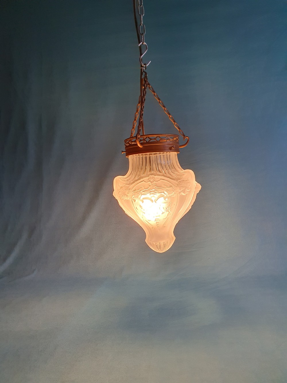 An early 20th-century glass pendant light with a frosted and moulded glass shade suspended by brass chains from a decorative brass gallery. View VIII