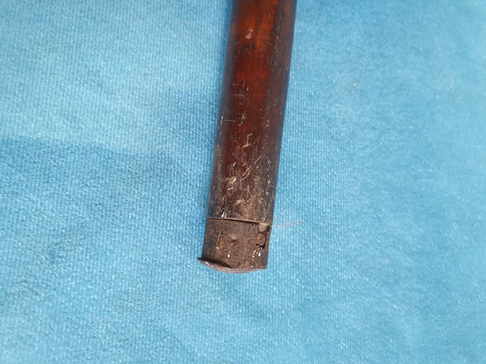 An antique cherry wood folding rod rest featuring carved faux bamboo turnings and a crossed X-frame structure. View V