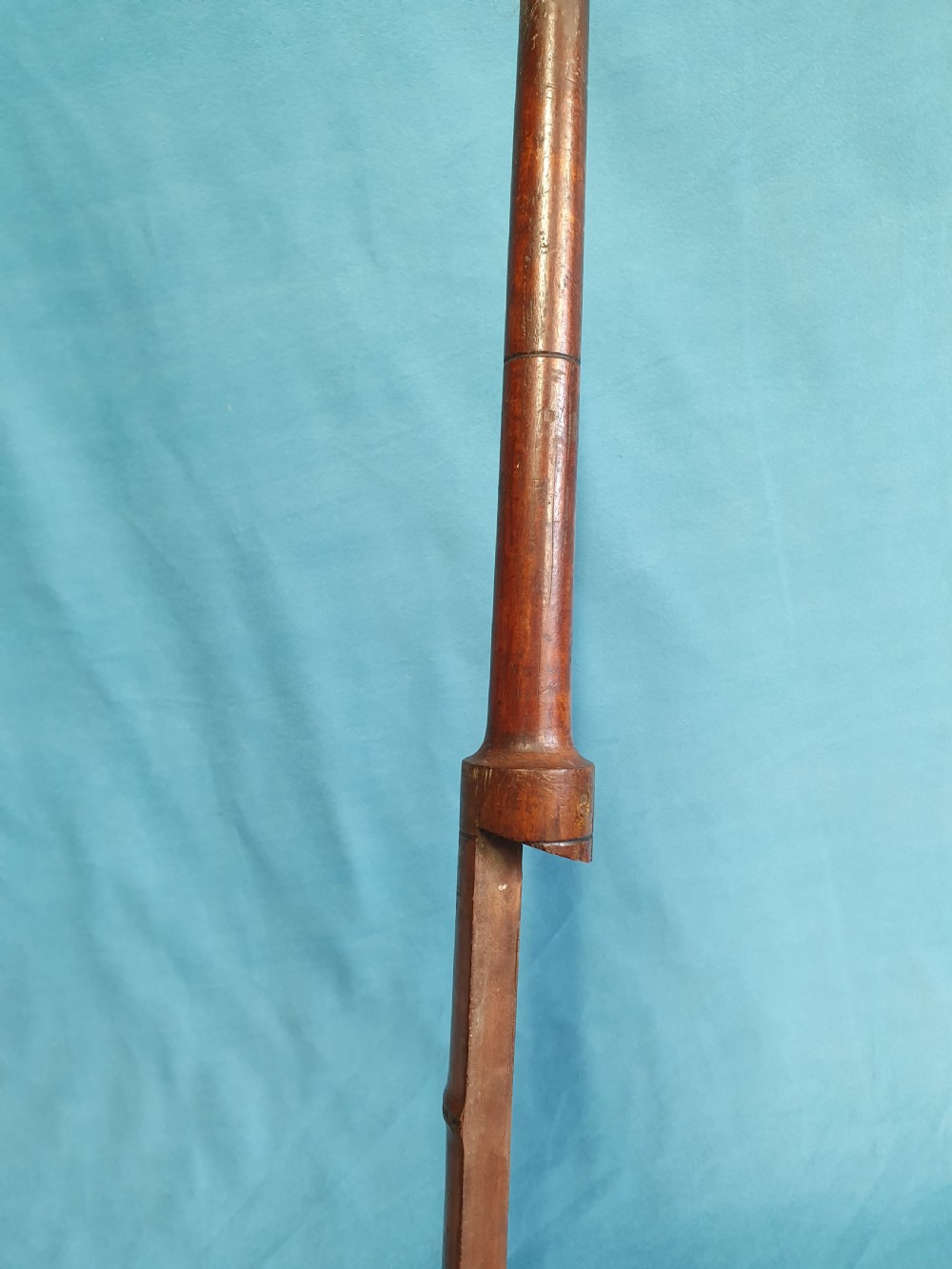 An antique cherry wood folding rod rest featuring carved faux bamboo turnings and a crossed X-frame structure. View VII
