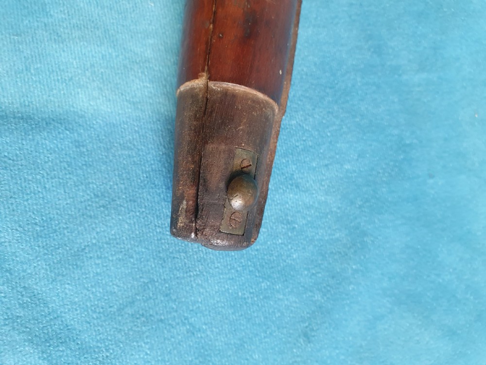An antique cherry wood folding rod rest featuring carved faux bamboo turnings and a crossed X-frame structure. View VIII