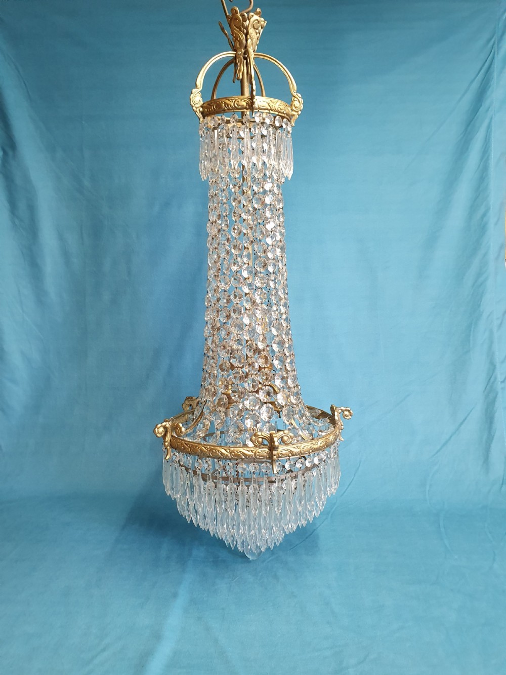 Elegant tall chandelier with six layers of spikes to the bottom
