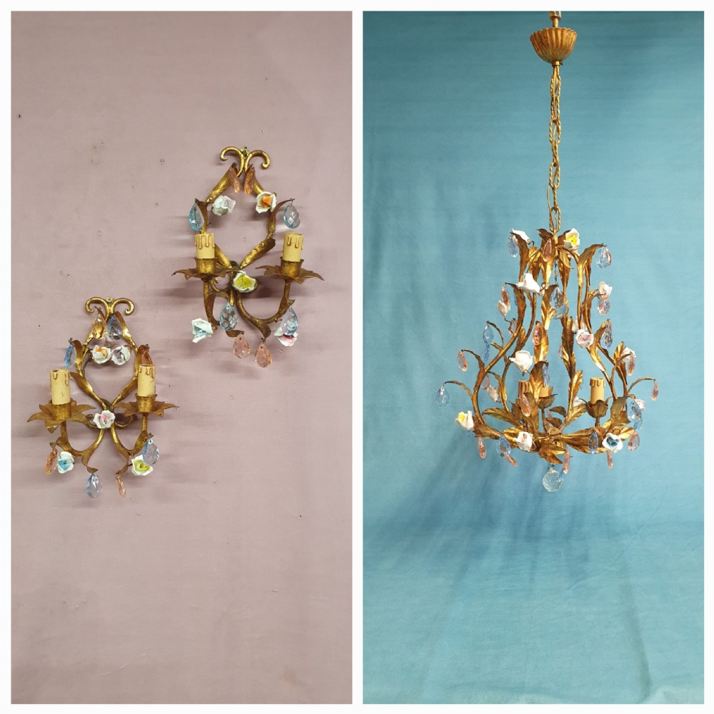 A French gilt metal chandelier and two matching two-arm wall sconces decorated with multi-coloured porcelain flowers and tinted crystal drops.