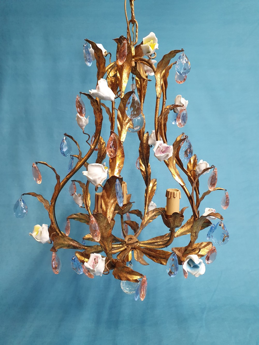 A French gilt metal chandelier and two matching two-arm wall sconces decorated with multi-coloured porcelain flowers and tinted crystal drops. View II