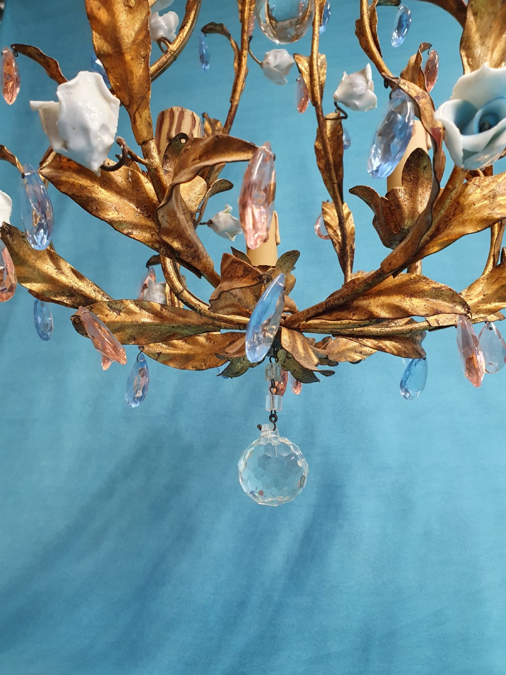 A French gilt metal chandelier and two matching two-arm wall sconces decorated with multi-coloured porcelain flowers and tinted crystal drops. View VI