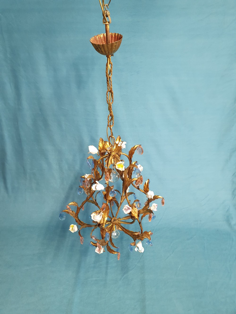 A French gilt metal chandelier and two matching two-arm wall sconces decorated with multi-coloured porcelain flowers and tinted crystal drops. View VIII