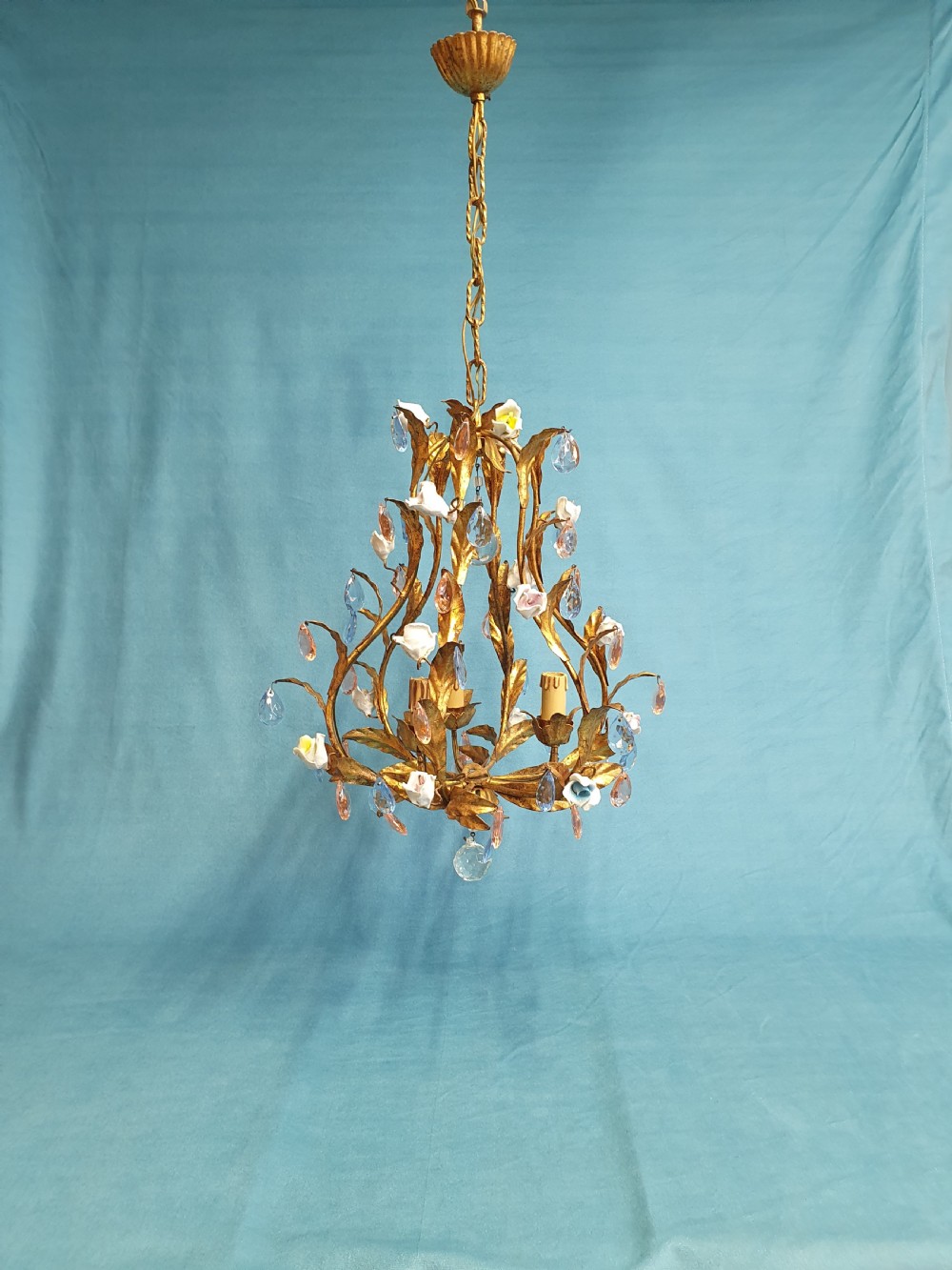 A French gilt metal chandelier and two matching two-arm wall sconces decorated with multi-coloured porcelain flowers and tinted crystal drops. View X