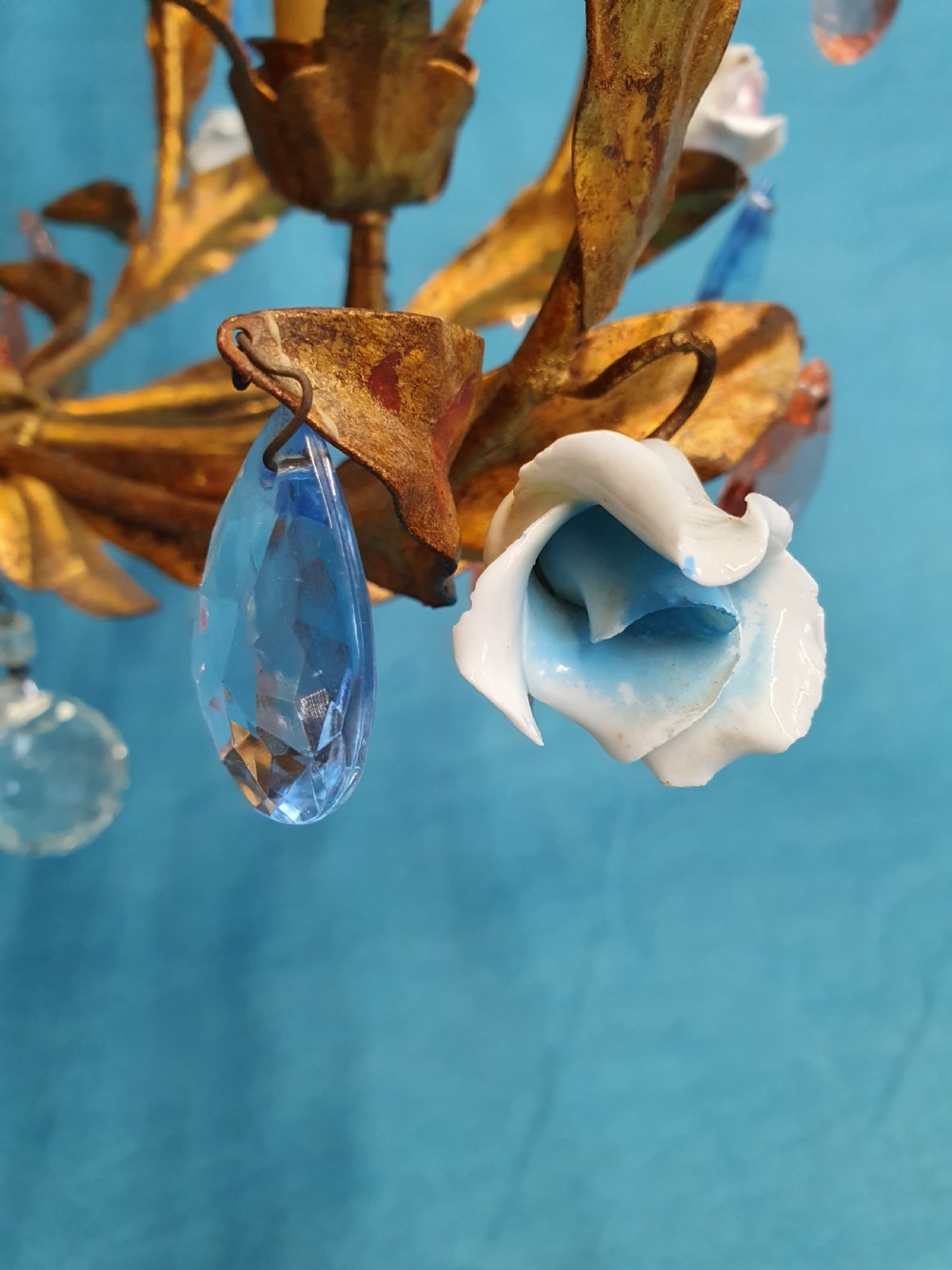 A French gilt metal chandelier and two matching two-arm wall sconces decorated with multi-coloured porcelain flowers and tinted crystal drops. View XII