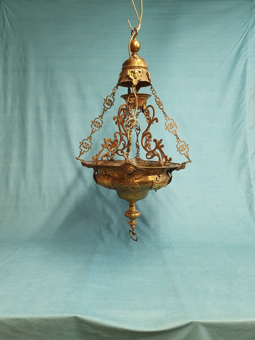 Brass light with cherub motifs to the periphery and interesting hanging construction to the top
