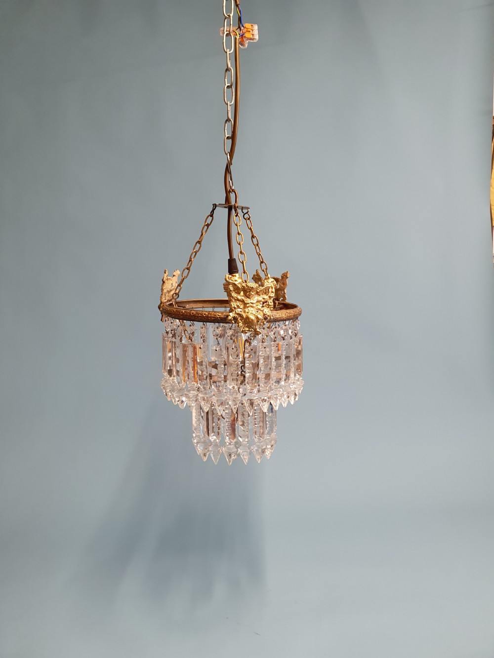 Chandelier with cherub of decoration to the top decorated with two tiers of lustres. 10