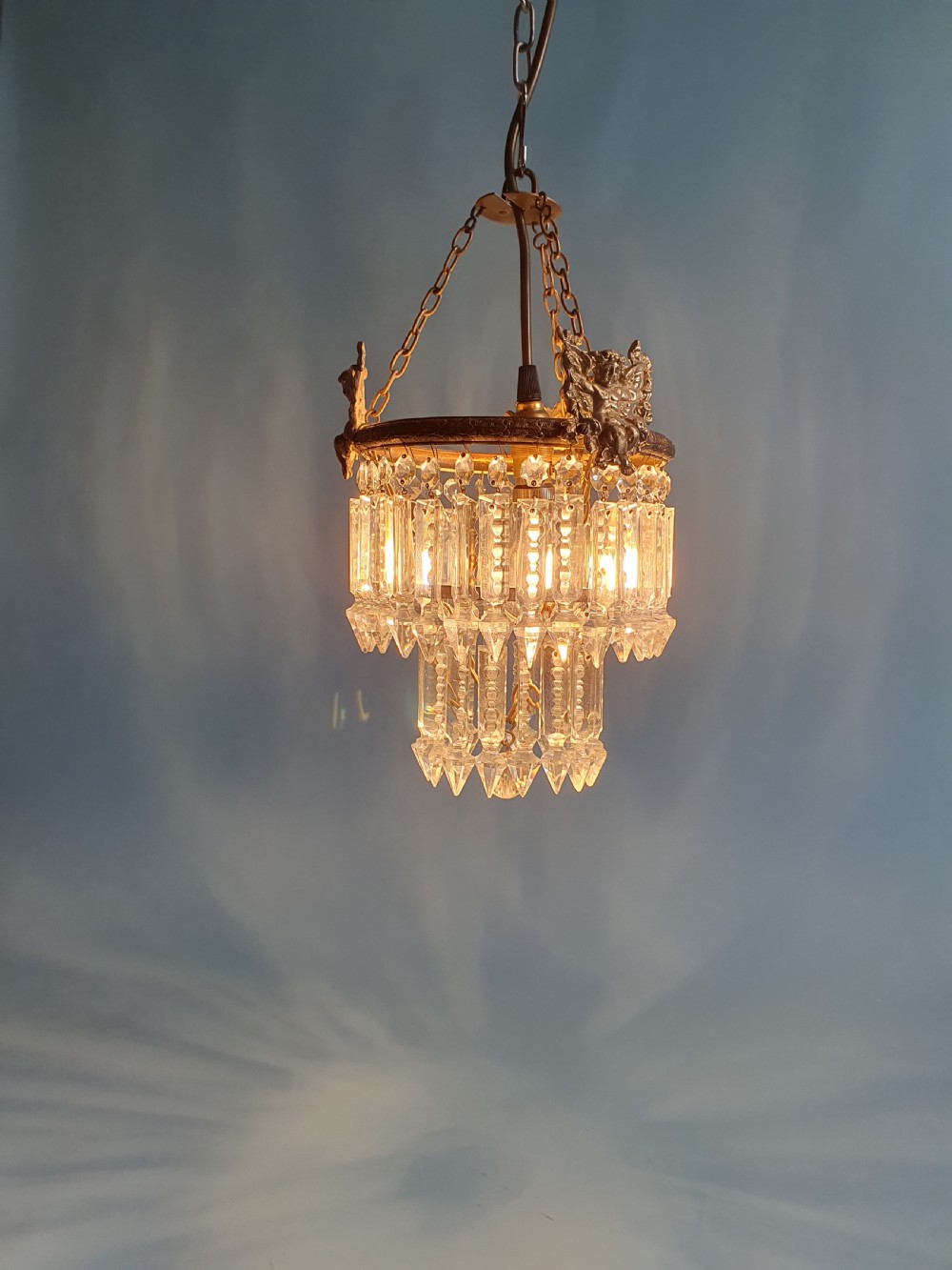 Chandelier with cherub of decoration to the top decorated with two tiers of lustres. 10