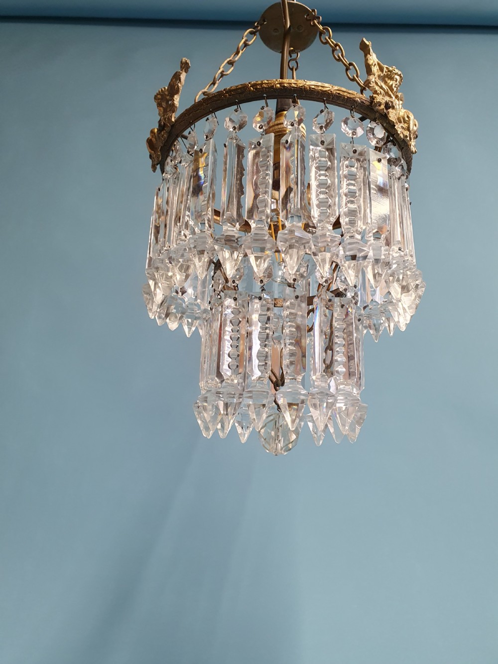 Chandelier with cherub of decoration to the top decorated with two tiers of lustres. 10