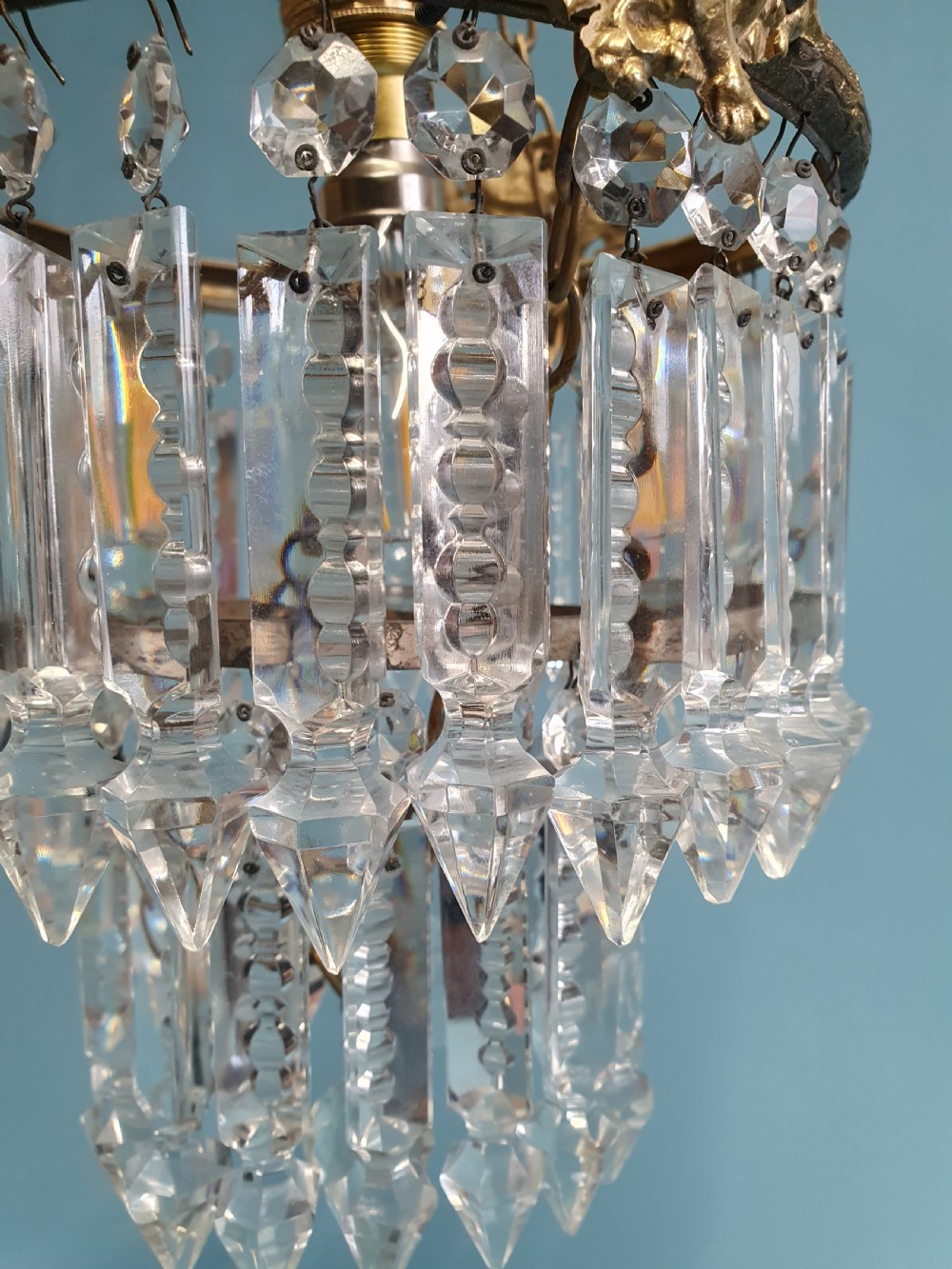 Chandelier with cherub of decoration to the top decorated with two tiers of lustres. 10