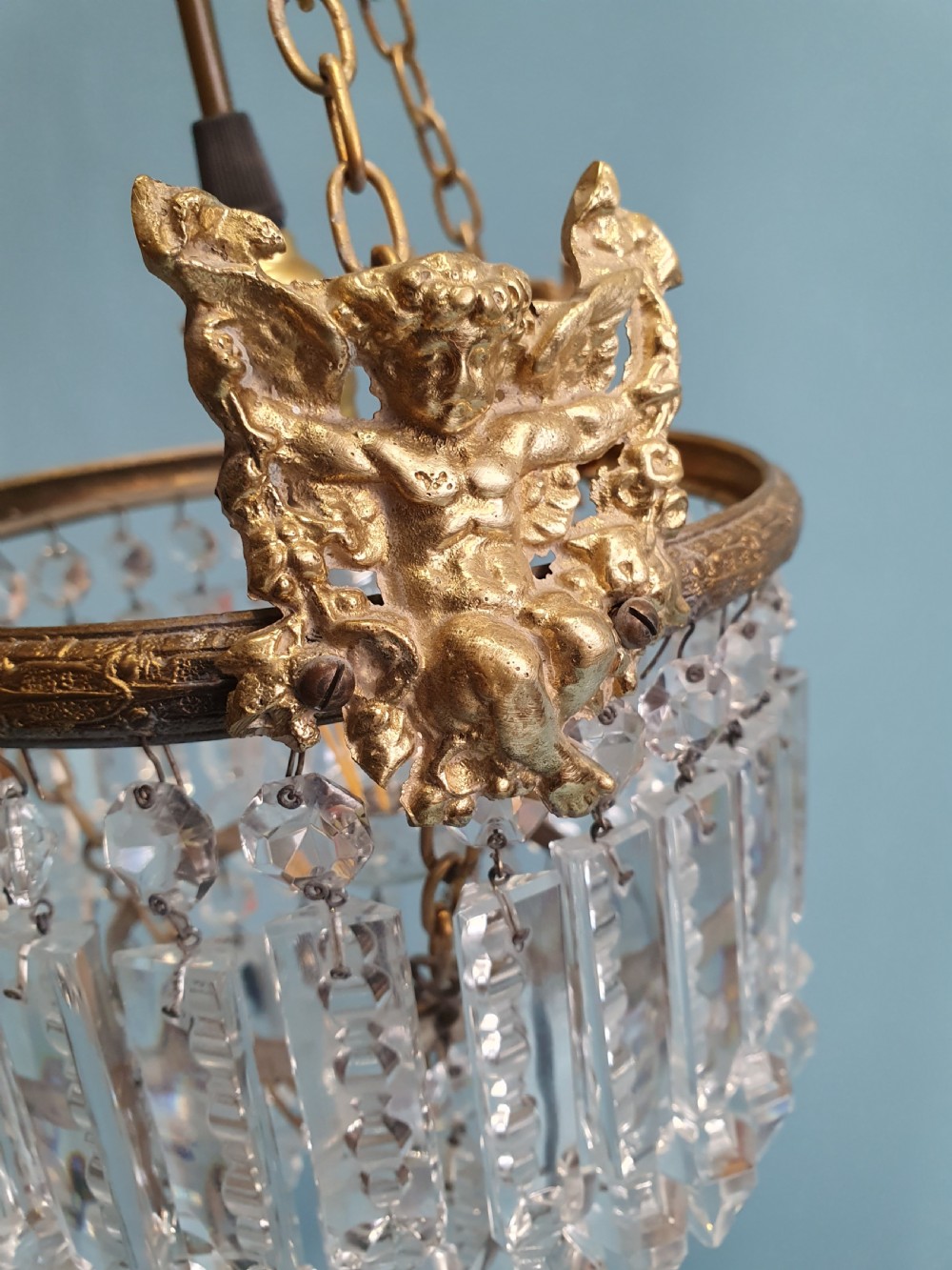 Chandelier with cherub of decoration to the top decorated with two tiers of lustres. 10