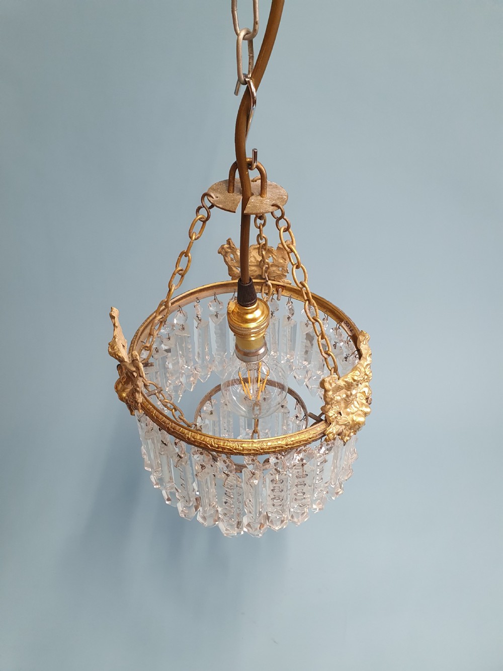 Chandelier with cherub of decoration to the top decorated with two tiers of lustres. 10
