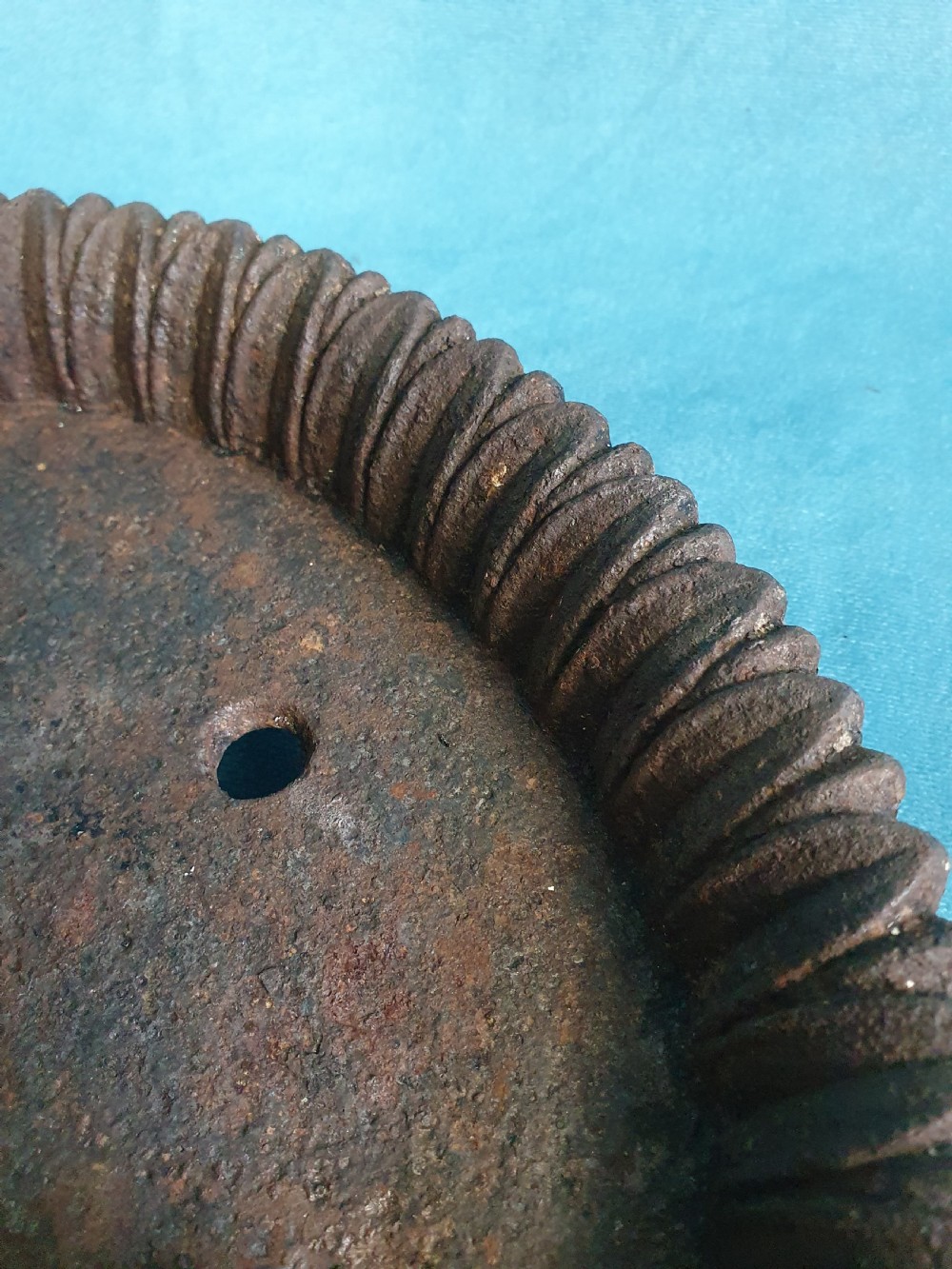 A 19th-century cast iron boot scraper featuring a dished oval tray base and two ornate scrollwork side supports holding a central scraping blade. View II
